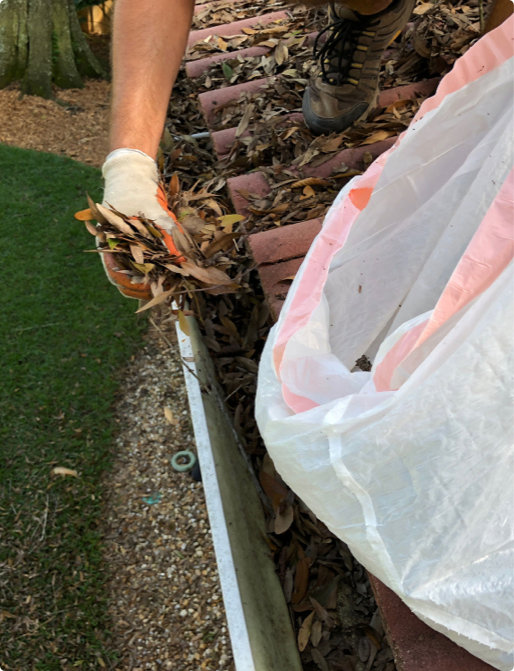 person cleaning gutter