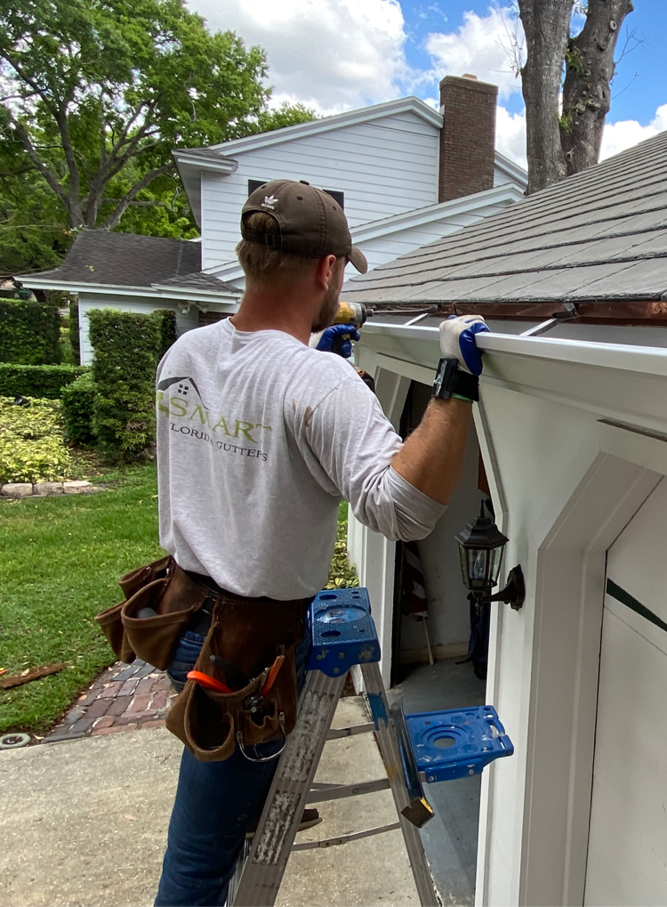 person repairing gutter