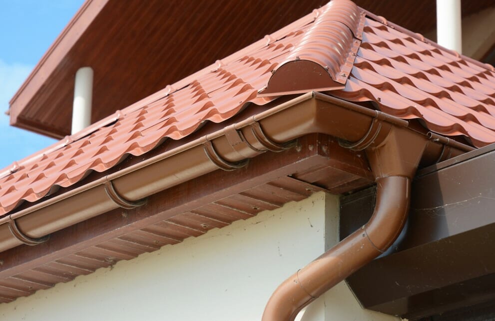 house with metal roof and gutter pipes