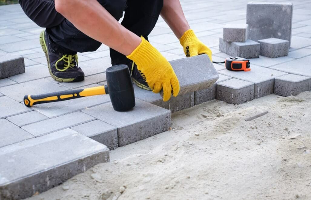 person installing paving stones